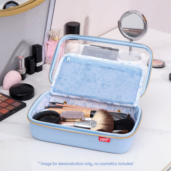 Blue makeup case with cosmetic items on a white surface
